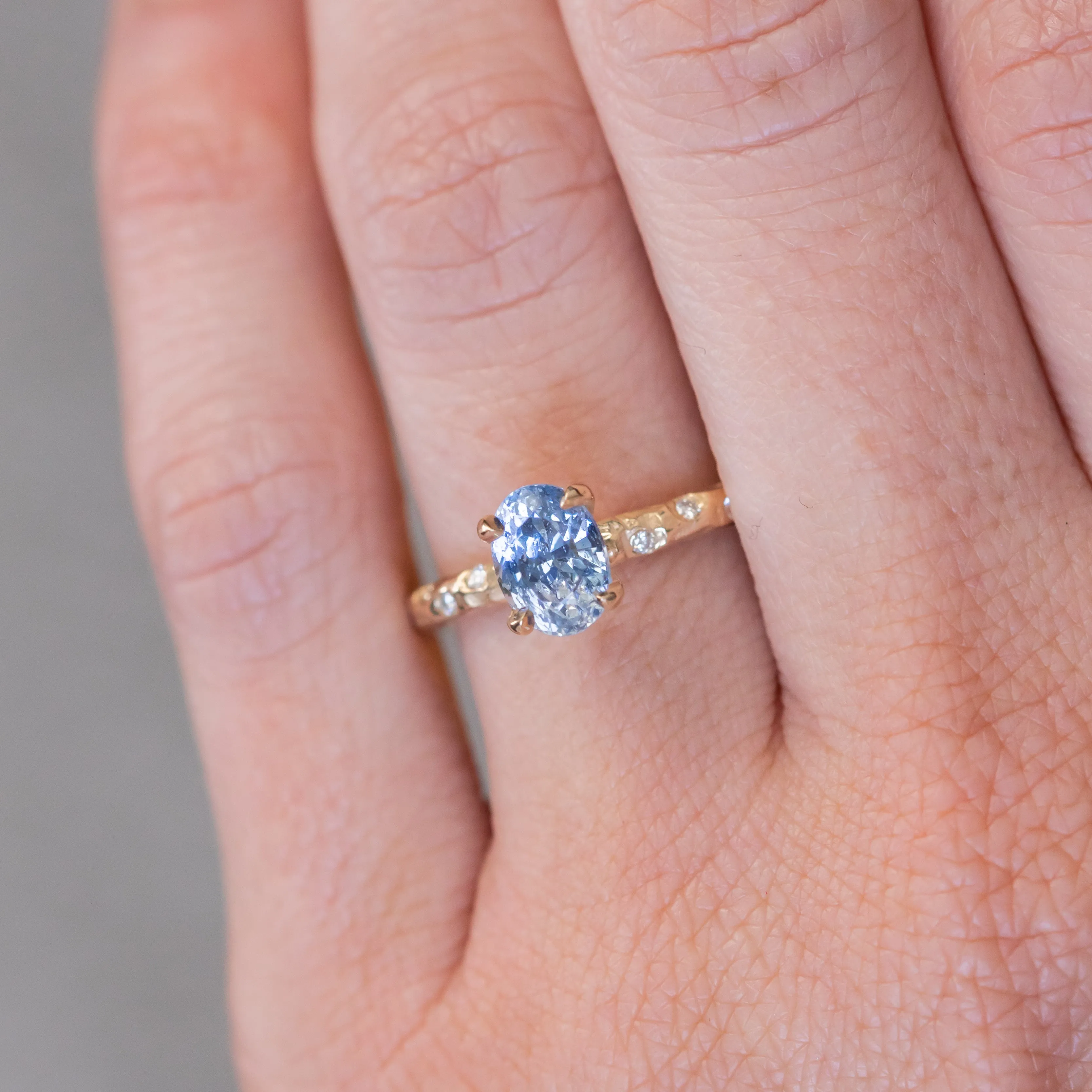 1.52ct Oval Blue Sapphire in 14k Yellow Gold Evergreen Solitaire with Scattered Embedded Diamonds