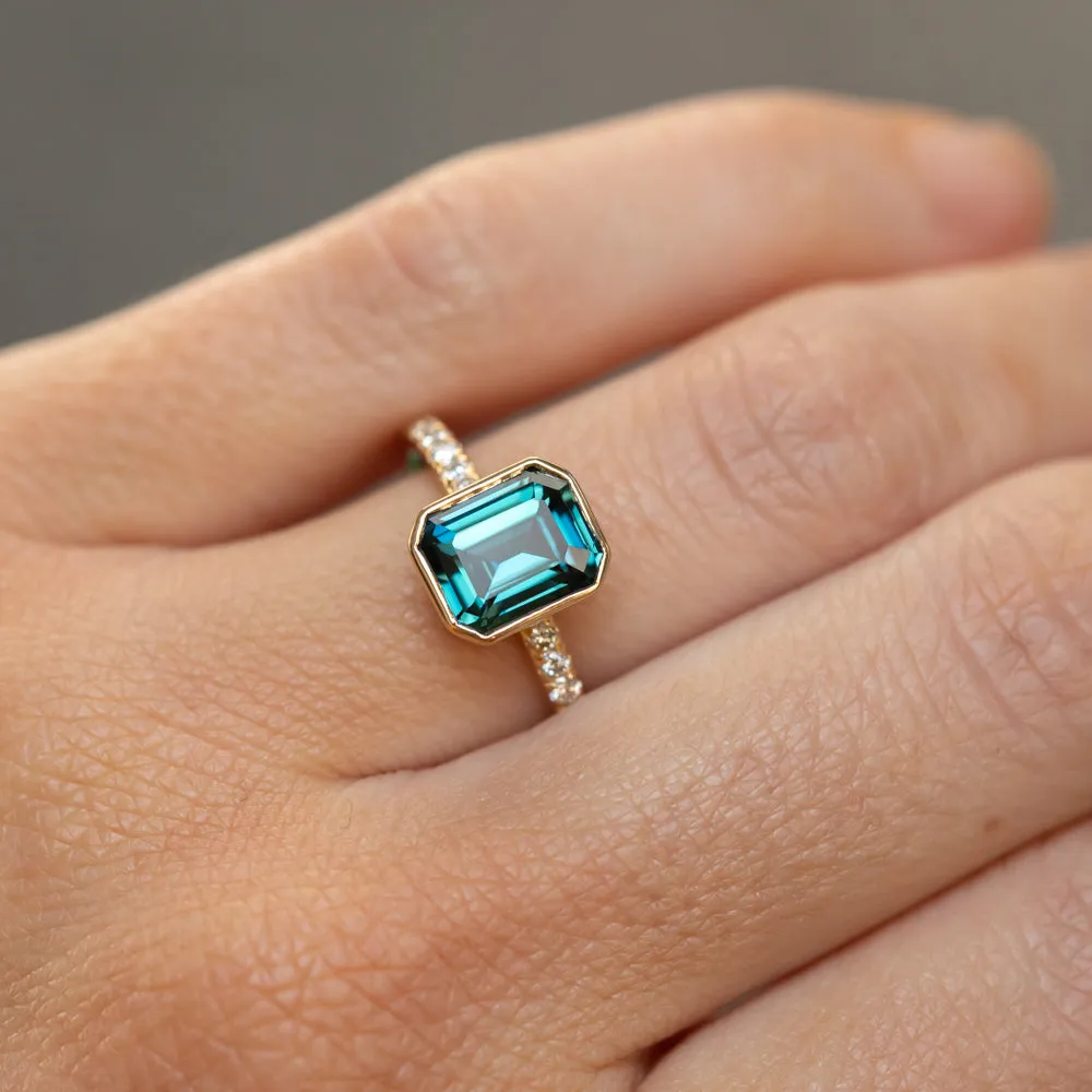 3.05ct Emerald Cut Color Shifting Teal Blue Green Sapphire Low Profile Bezel with French Set Diamonds 18k Yellow